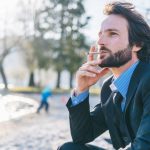 Businessman Smokes Joint by Lake