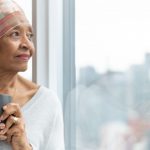 Portrait Senior Woman With Cancer Looking Out Window