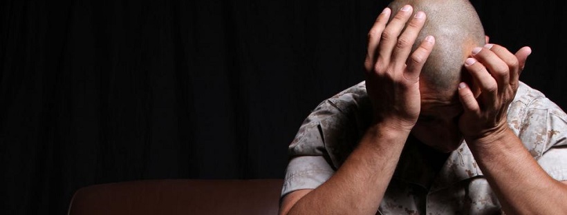 Man Suffering from PTSD Head in Hands