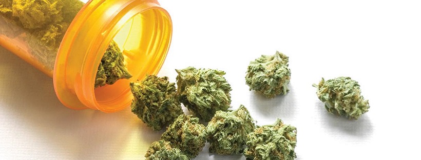 Marijuana Flower Spilling Out of Pill Bottle onto Table